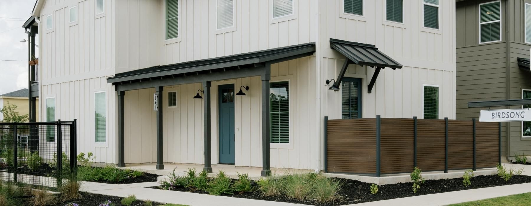 a building with a fence and a yard